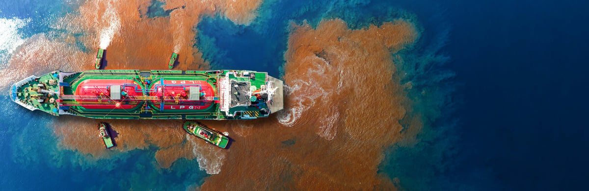 Oil film spreading across the surface of the sea