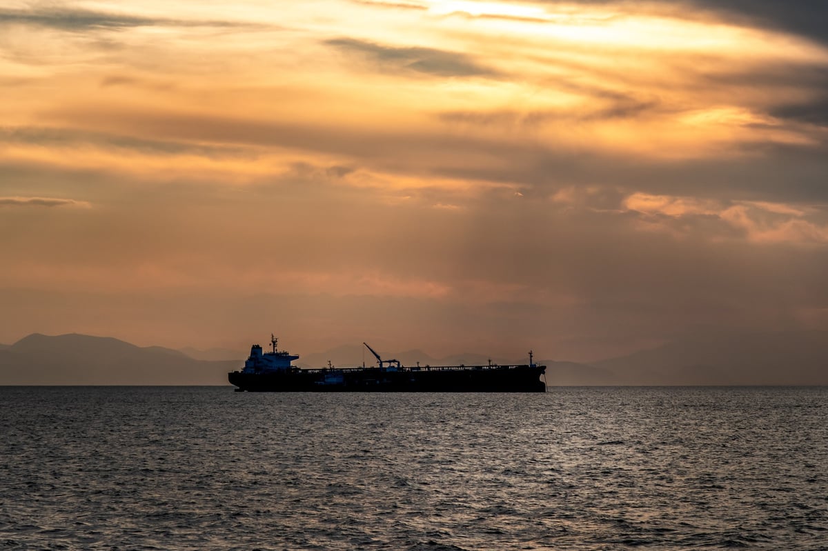 Crude oil tanker under way at sunset
