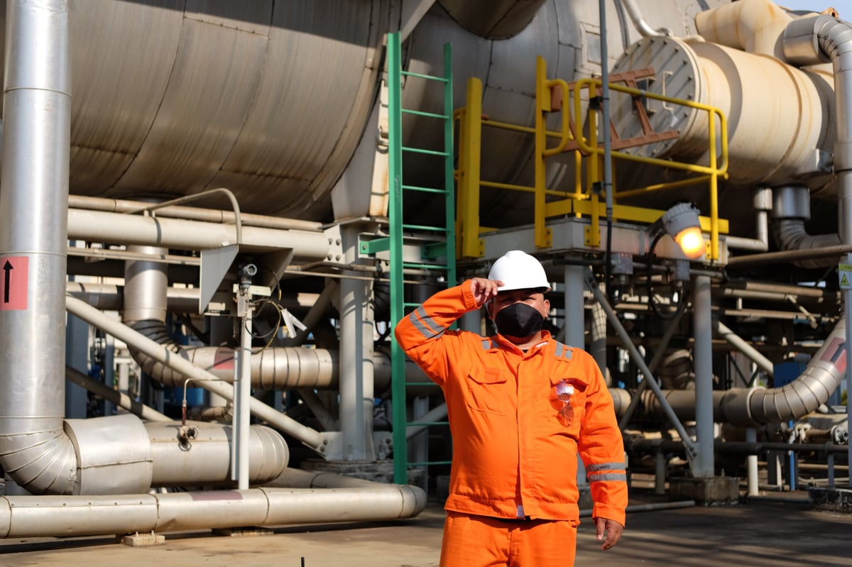 Ghanaian worker in coveralls and hard hat at a response site